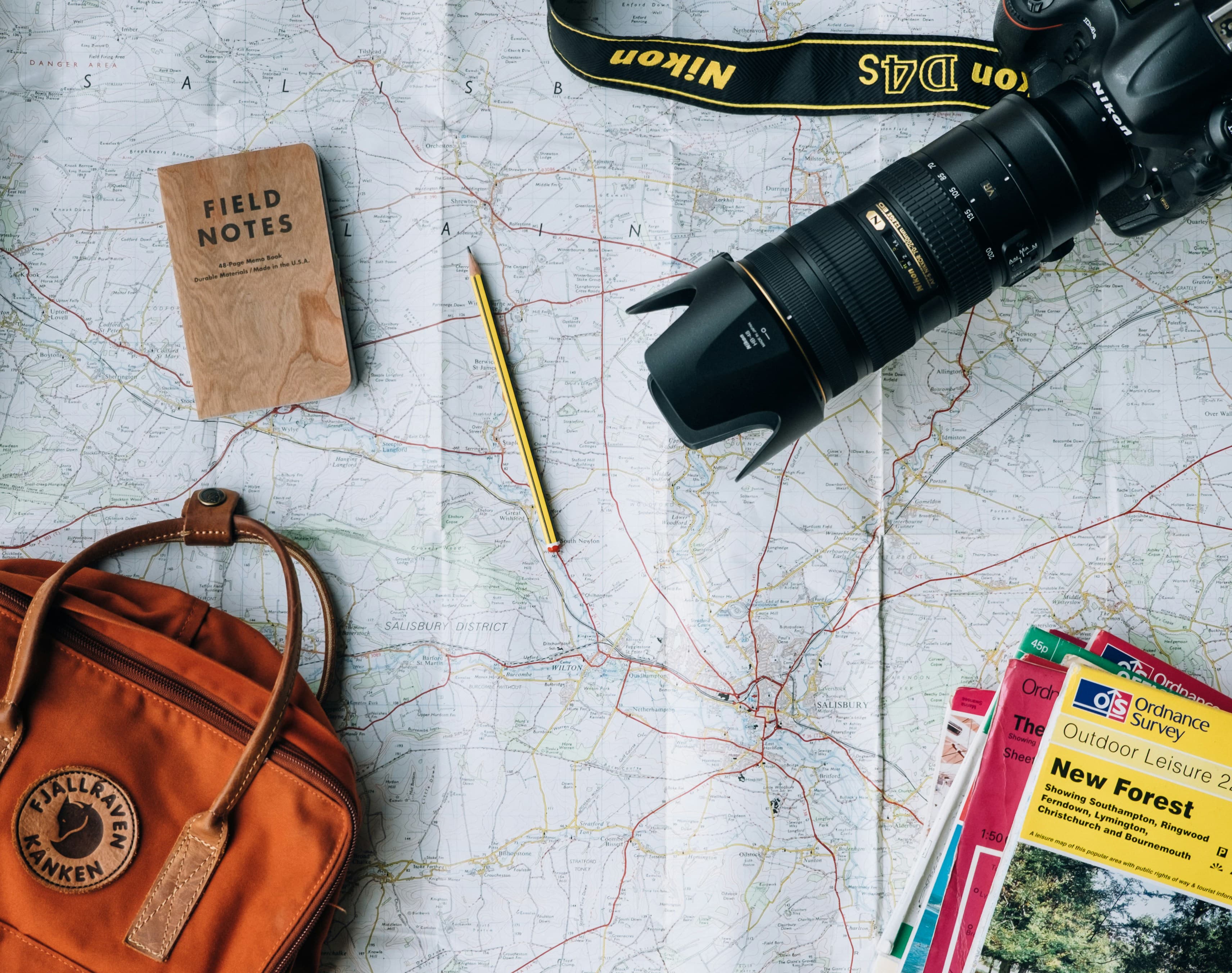 Map, backpack, camera and notebook ready for a trip